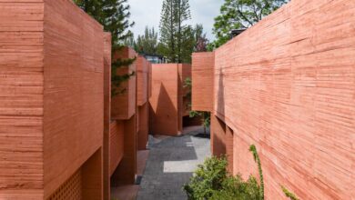 Photo of Perforations characterise coloured concrete housing block in Mexico City