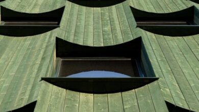 Photo of Curved panels of green timber clad office in Norway by Oslotre