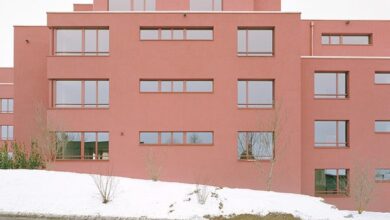 Photo of Ductus coats blocky apartment complex with red plaster in Switzerland