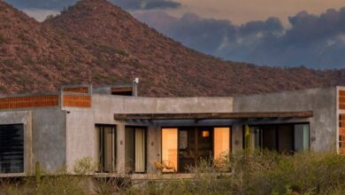 Photo of RED Arquitectos integrates corn millstone into facade of Mexican house