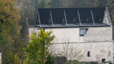 Photo of Medprostor encloses 12th-century church with folding roof in Slovenia