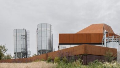 Photo of ODOS Architects crowns distillery with pyramidal Corten roofs